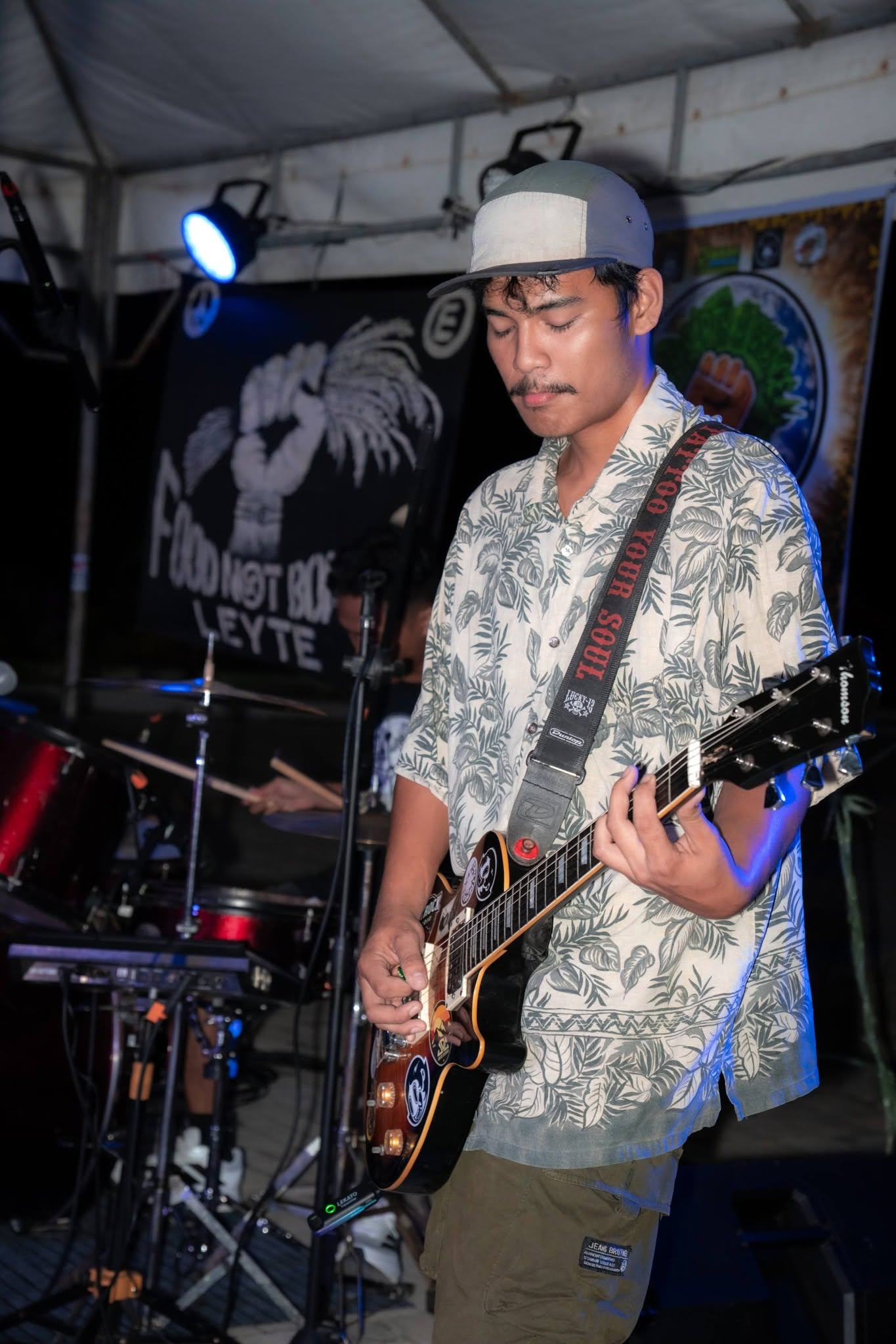 Portrait of Rai Prosper Mercedes playing guitar